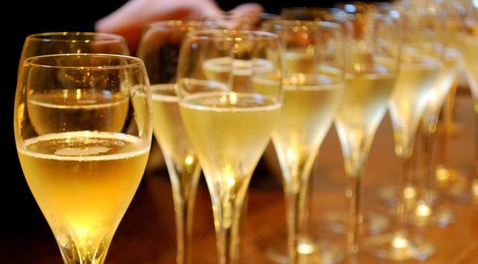 Line of champagne glasses on bar